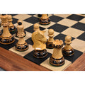 Close-up perspective of 1970s Dubrovnik lacquered boxwood pieces positioned on a dark and light wood chessboard.