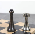 Detail shot of a 3.1 inch Tower Series dark brass bishop next to a shiny silver brass rook on the board.
