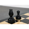 Close-up of a black ebonised Bishop and Pawn on a premium wood chessboard.