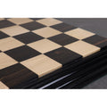 Detail shot of the raised wooden squares on a luxury maple and ebony chess board.