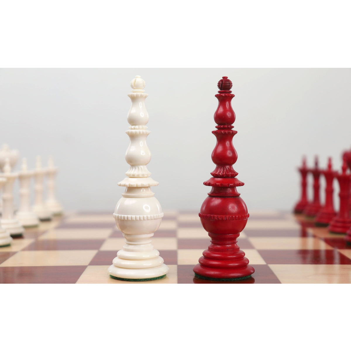 Crimson and white Turkish Tower pre-Staunton chess pieces close up.
