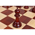 Detailed view of a hand-carved bud rosewood Staunton bishop chess piece on a board.