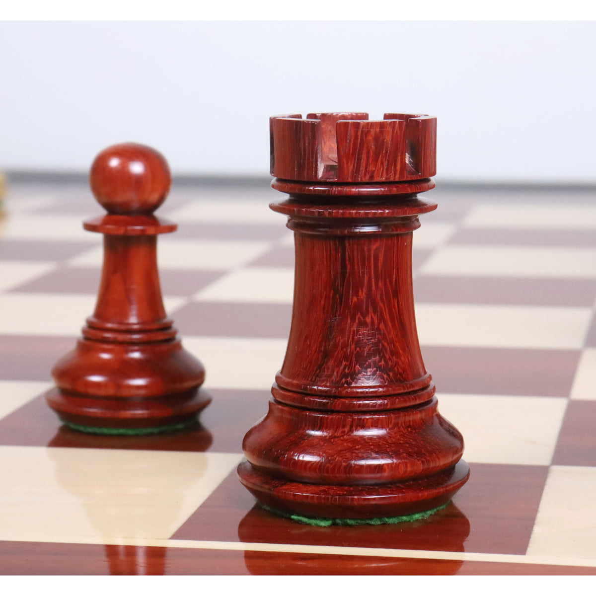 Triple-weighted 4.6" Spartacus rook and pawn in premium Bud Rosewood.