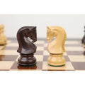 Dark rosewood and light boxwood Zagreb style knight chess pieces facing each other.