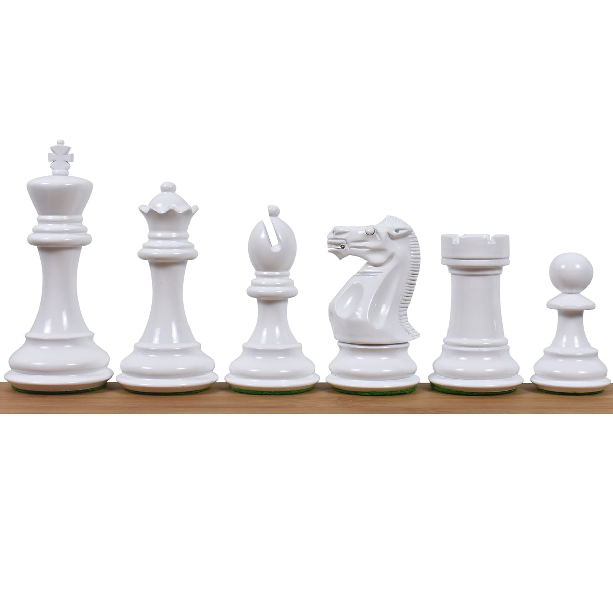 A line-up of white weighted Staunton chess pieces on a wooden surface.