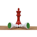 Close-up of a red Pro Staunton king chess piece displaying its felted base.