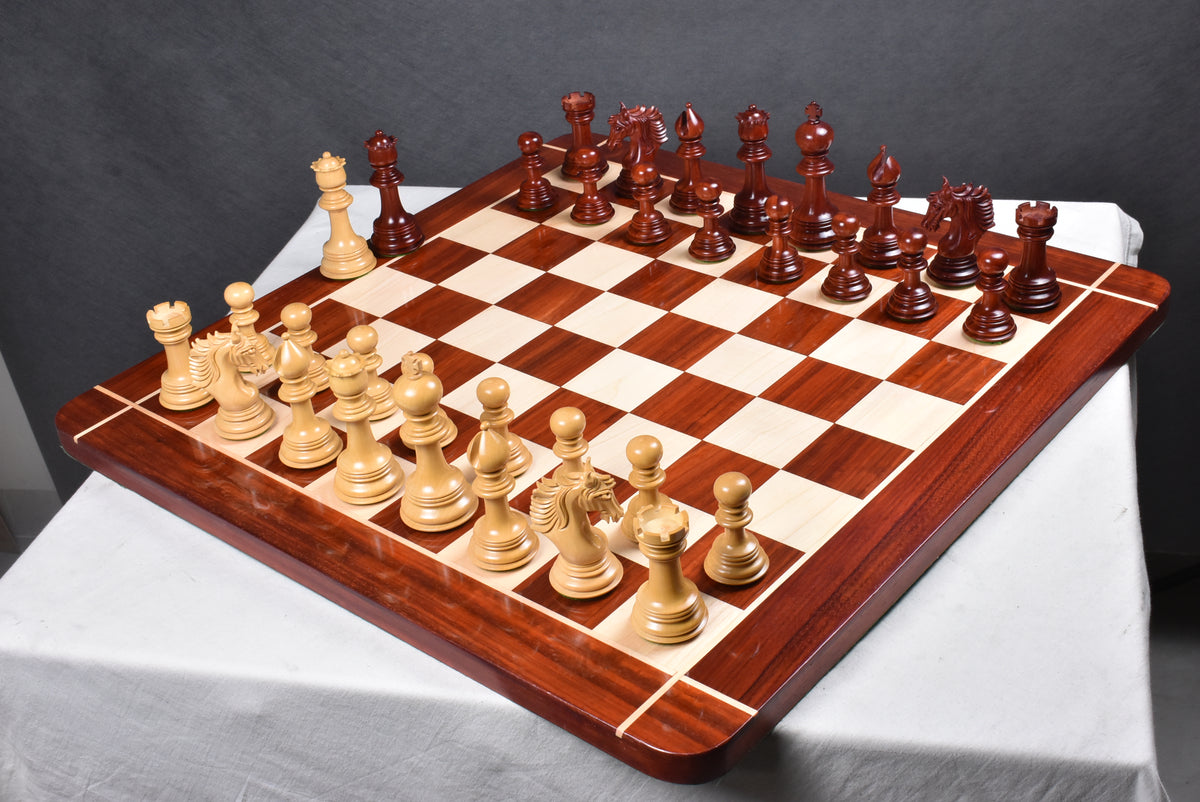 Full Arthur luxury Staunton chess set with Bud Rosewood and boxwood pieces on a wooden board.