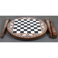 Disassembled 20-inch round chess table showing the solid sheesham top and three floral carved legs.