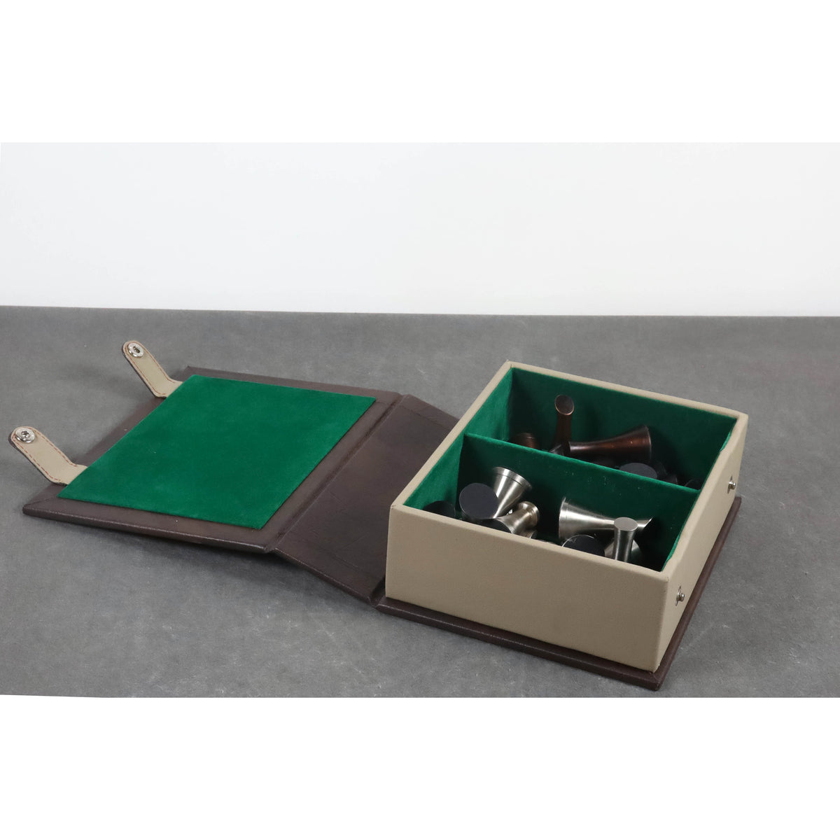 Flat-lay view of the leatherette chess pieces storage case holding weighted chessmen within its green compartments.