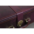 Macro shot of contrast stitching and brass accents on the burgundy chess coffer box.