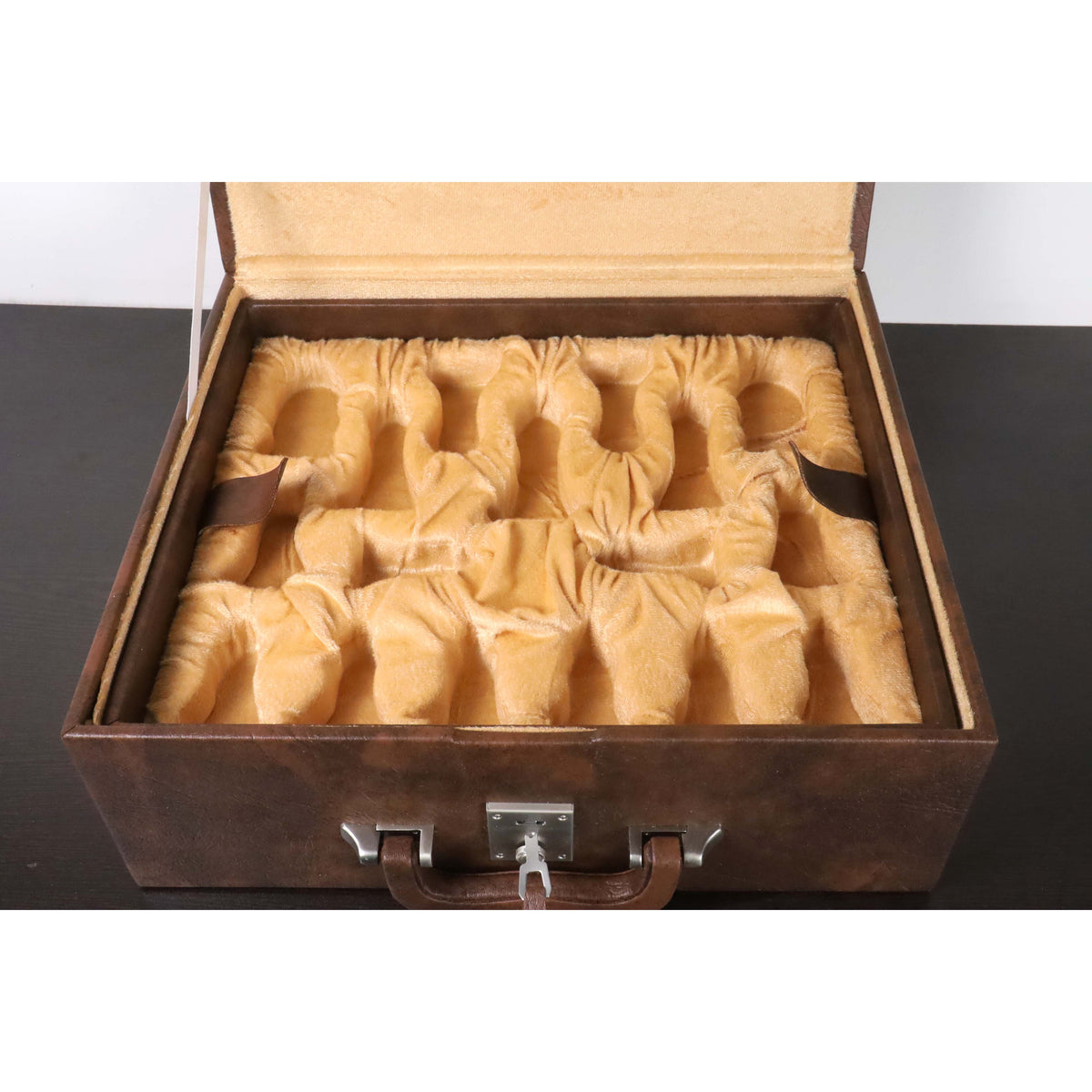 Velvet-lined interior tray with custom-molded slots inside a tan brown chess storage box.