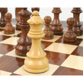 Close-up of a premium boxwood queen piece standing on a wooden chess board with a shallow depth of field.