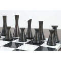 Side profile of the 3.1" Tower Series black brass chess pieces on a marble board.