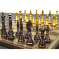 Antique copper brass chess pieces in sharp focus against a bokeh background of gold pieces.