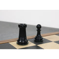 Sturdy black stained camel bone rook and pawn pieces with felted bases on a chess board.