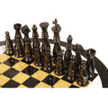Weighted black nickel brass chess pieces displayed on a circular executive chess table.