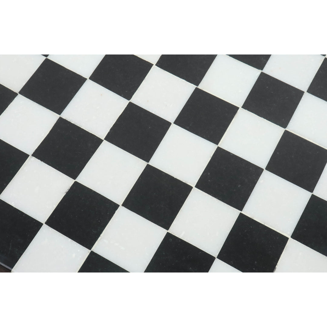 Detailed texture of polished black and white marble squares on a premium stone chess board.