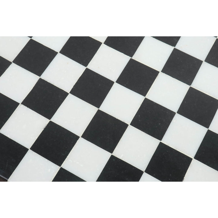 Detailed texture of polished black and white marble squares on a premium stone chess board.