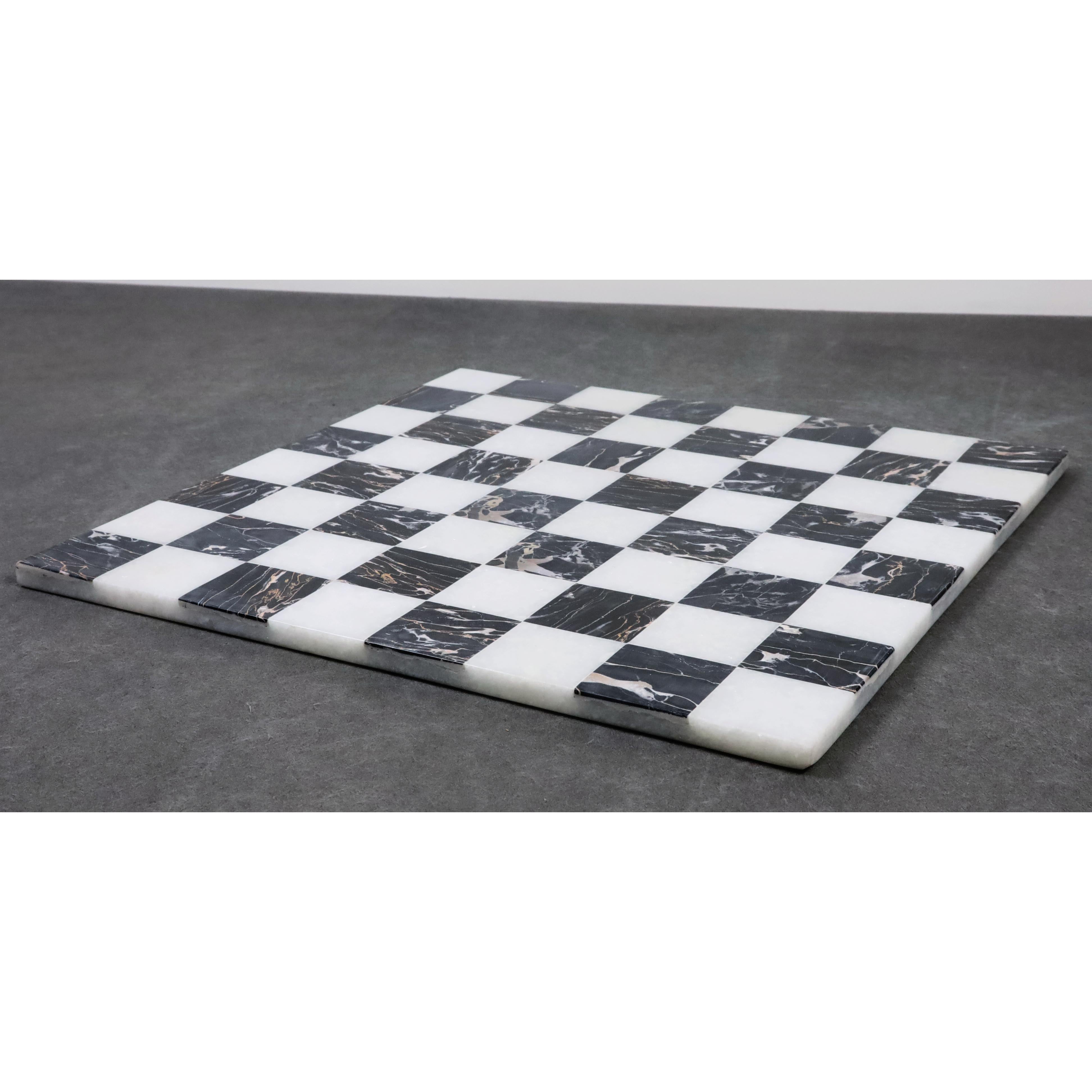 Contemporary 15 inch marble chess board in black and white stone on a grey background.