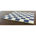 Side profile of a slim 18 inch borderless marble chess board in lapis lazuli blue and white.