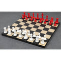 Full 1849 Jacques Cook camel bone luxury chess set in crimson and white on a wood chessboard.