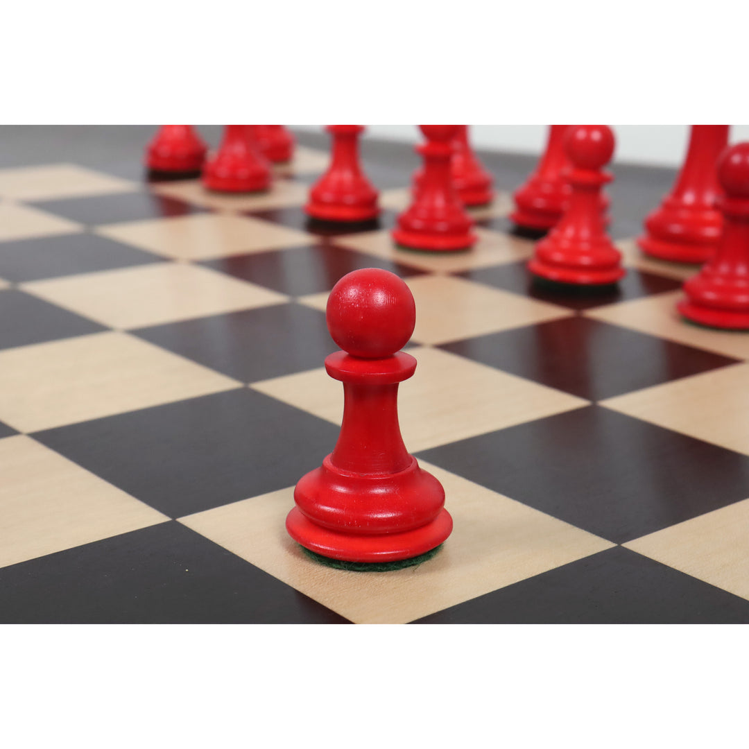 Single crimson camel bone pawn piece from the 1849 Jacques Cook set on a black and maple board.