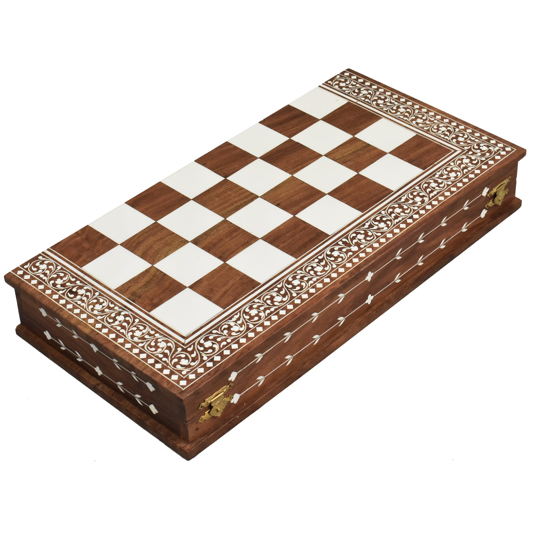 Folded golden rosewood chess board showing intricate faux ivory floral carvings on the side.