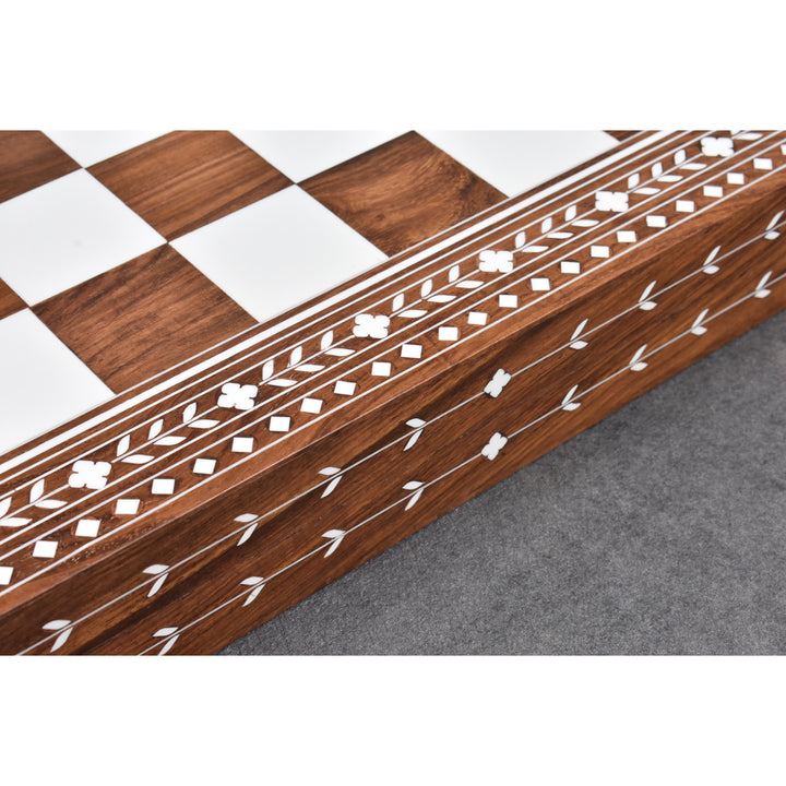 Detailed view of the side profile and intricate leaf-patterned acrylic inlays on a rosewood board.