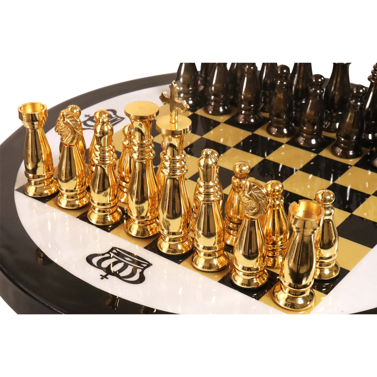 Polished gold brass chess pieces standing on a high-gloss black and gold chessboard.