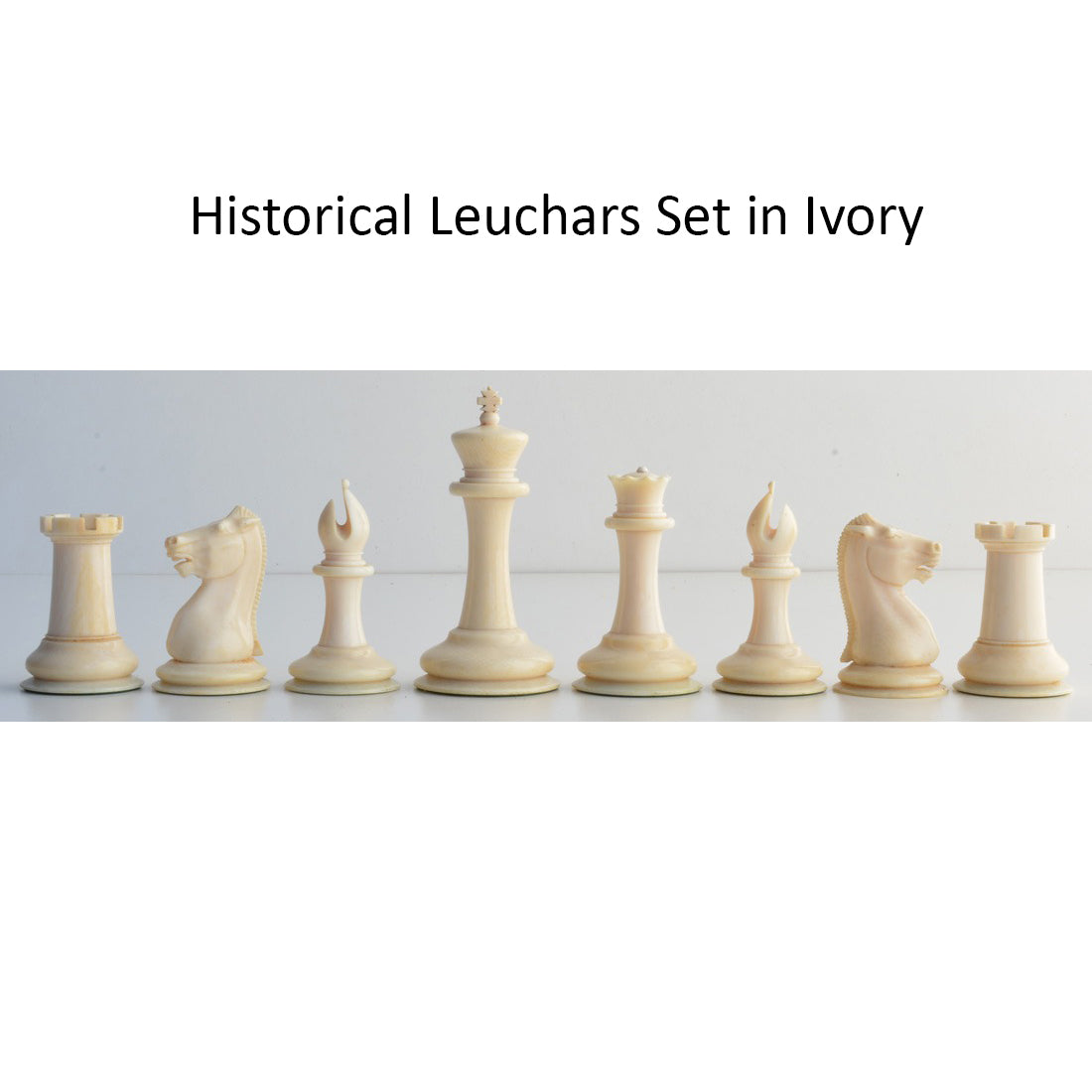 Antique style ivory Leuchars Cook Staunton chessmen displayed in a full horizontal row.
