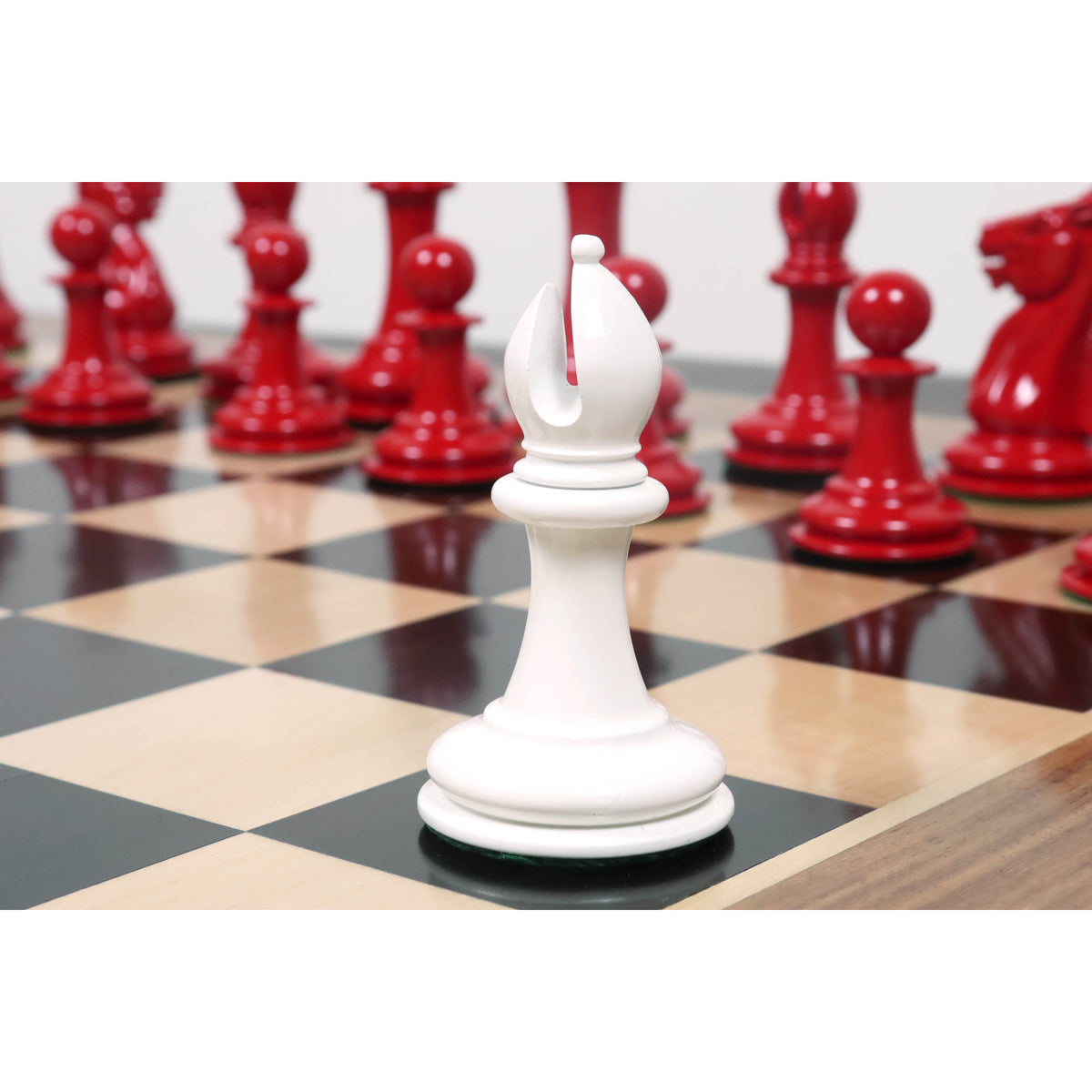 A 4.5 inch ivory white lacquer bishop piece standing on a wooden chess board with a crimson set behind.