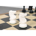 Close-up of two white camel bone knights showing intricate hand-carved details and vintage aesthetics.