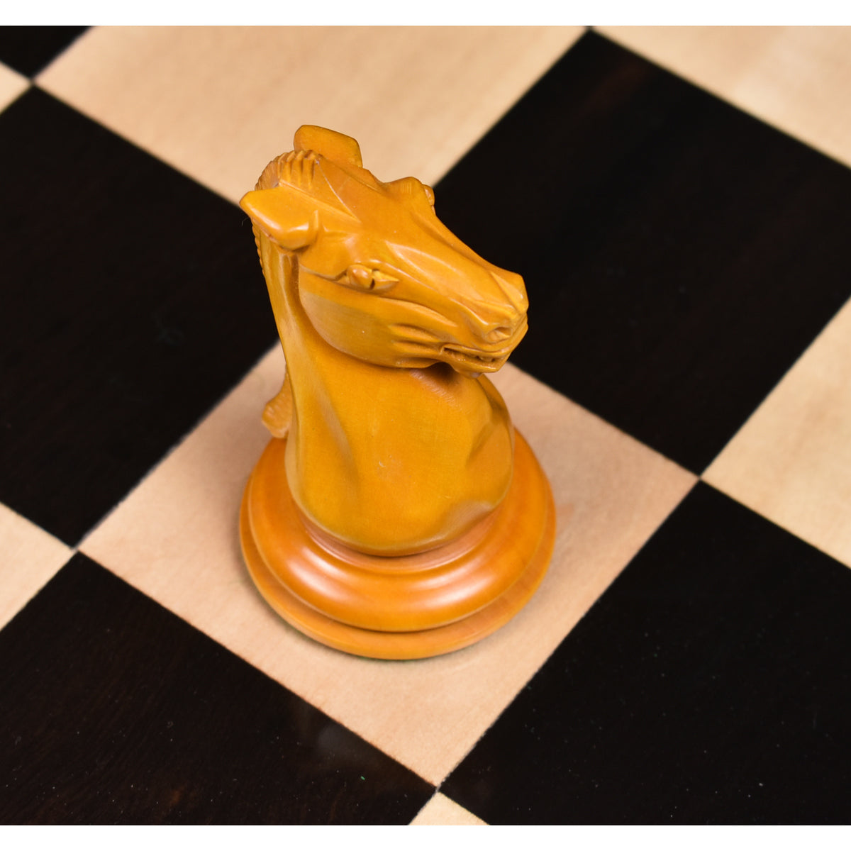 Close-up of a hand-carved antiqued boxwood knight from the 1849-50 Leuchars Cook Staunton chess set.
