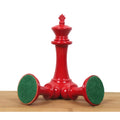 Crimson lacquer King piece with two pieces resting to show green felt billiard cloth bases.