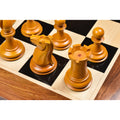 Detailed carving of an antiqued boxwood Knight and Rook with stamped red crown insignias.