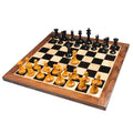 Full 1849 Leuchars Cook Staunton chess set in ebony and antiqued boxwood on a walnut board.