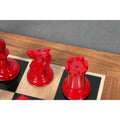 Crimson lacquer knight and rook with king-side stamps from the 1849-50 Leuchars Cook Staunton set.