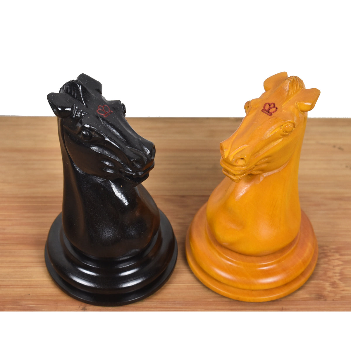 Side-by-side comparison of the hand-carved ebony and antiqued boxwood Staunton Knights.
