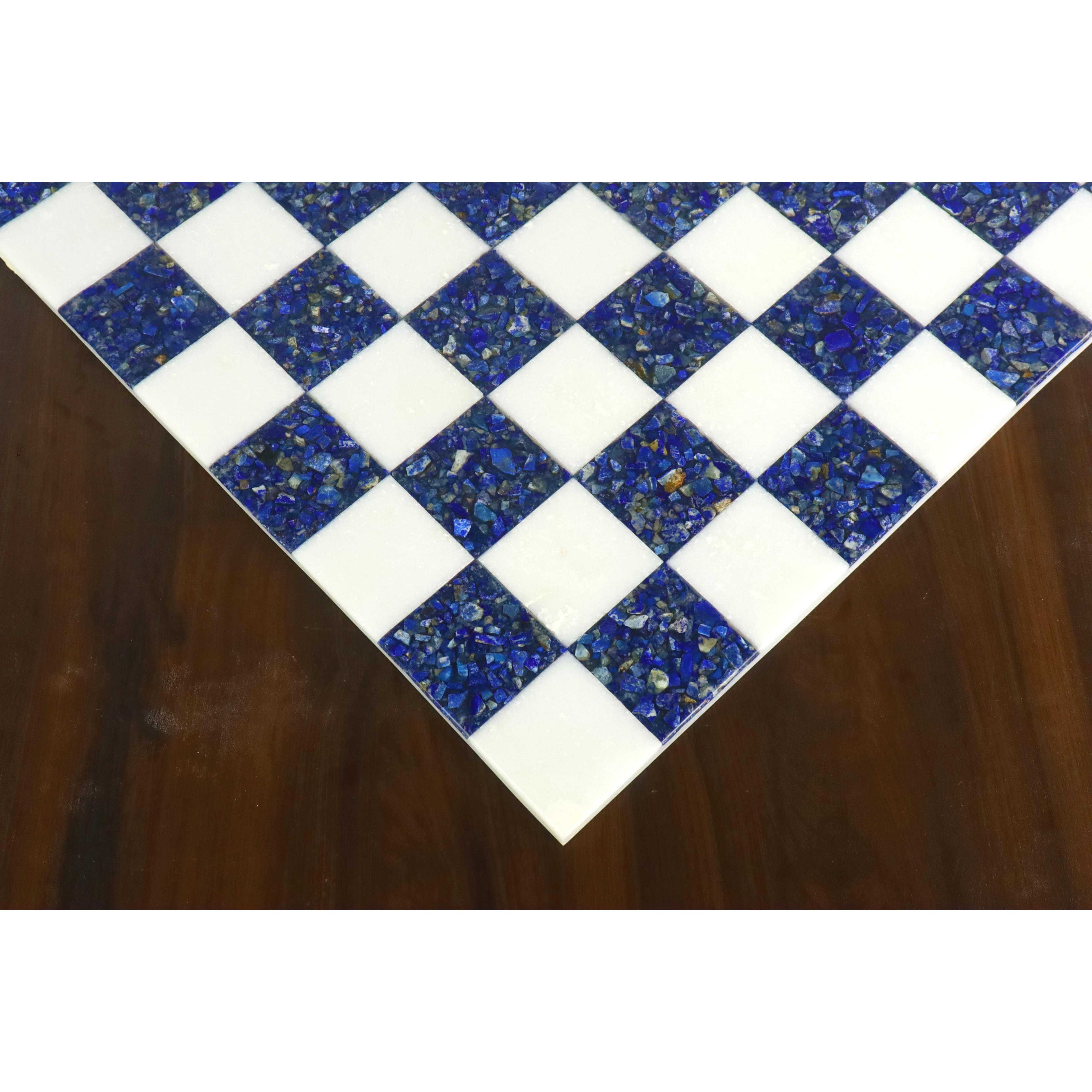 Close-up of the corner of a luxury lapis lazuli and white marble chess board on a wooden table.