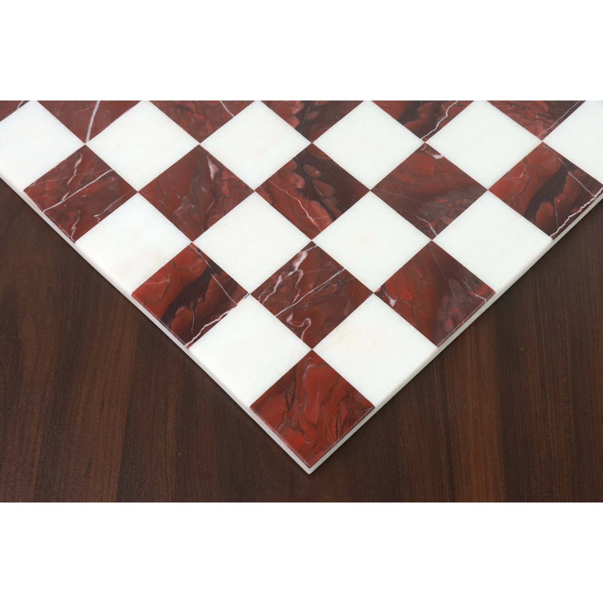 Corner detail of a borderless marble chess board highlighting the seamless semi-precious stone inlay.