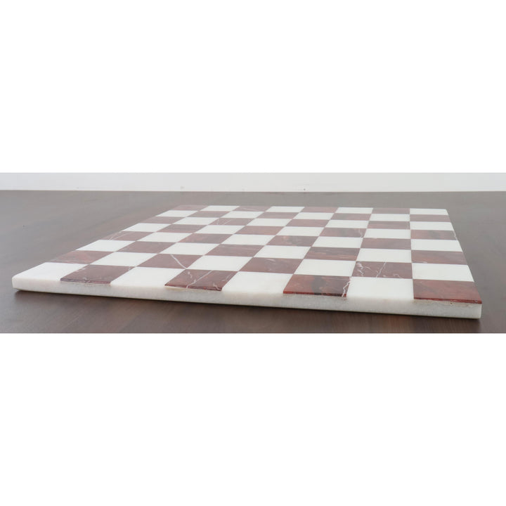 Side view of a slim, luxury marble chess board showing the smooth polished edge and inlaid stones.