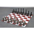Modern metal chess pieces arranged on a 15 inch red and white marble stone board.