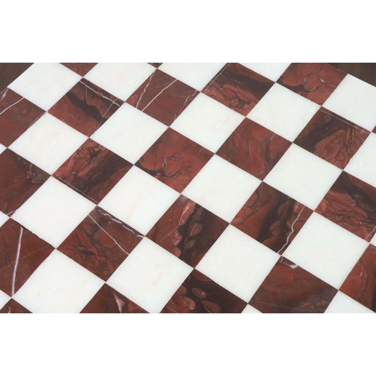 Detailed view of the precision inlay work on a maroon and white marble stone luxury chess board.