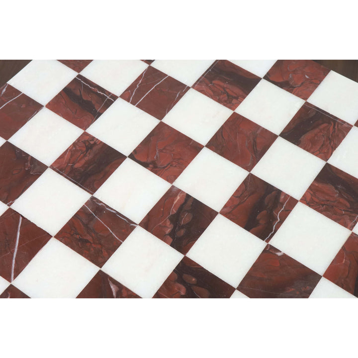 Detailed view of the precision inlay work on a maroon and white marble stone luxury chess board.