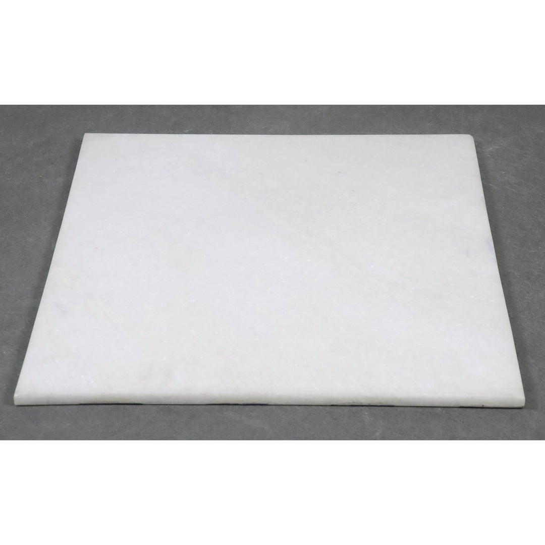 Underside of a luxury stone chess board showing the solid white marble base.