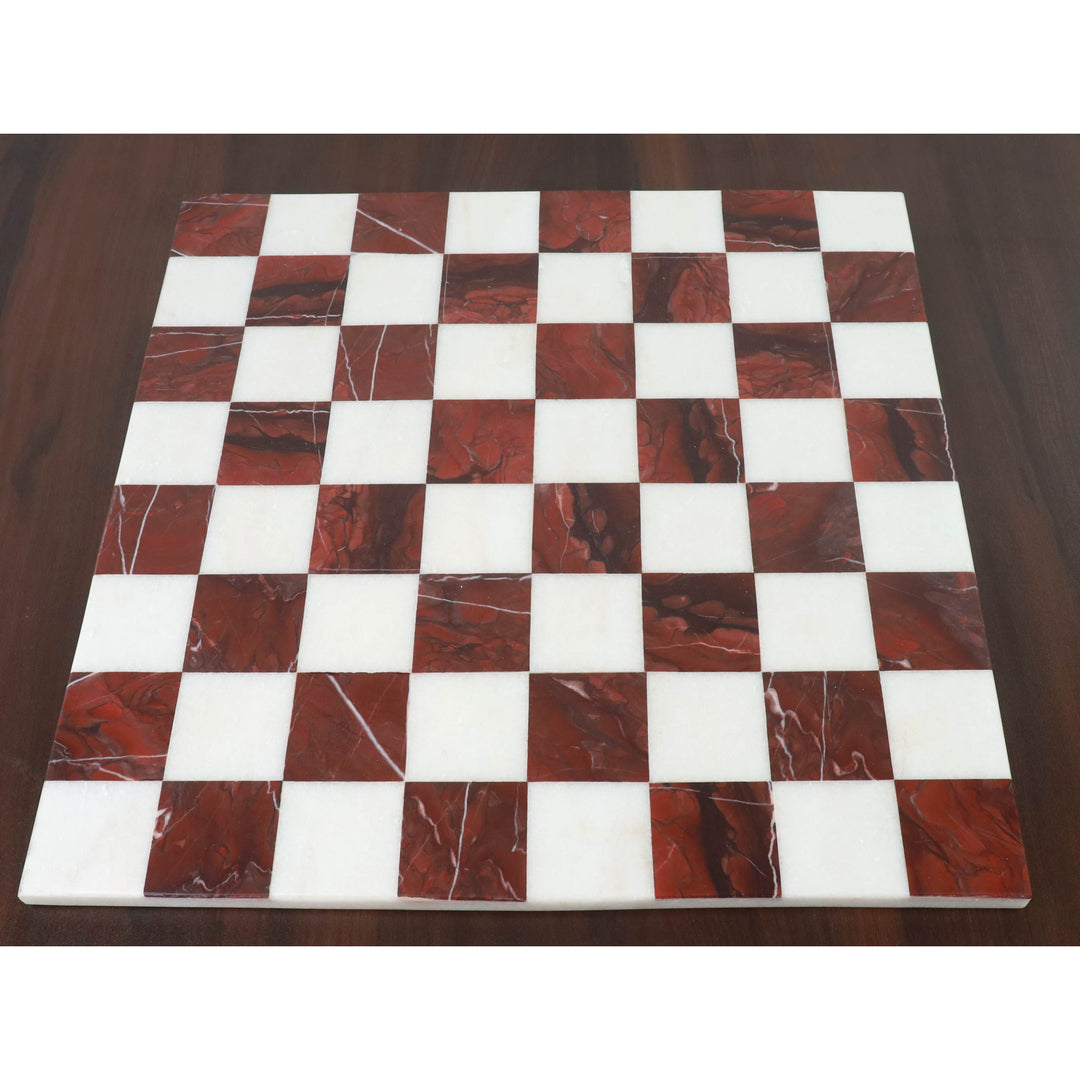 Overhead view of a square 15 inch marble chess board featuring maroon and white inlaid squares.