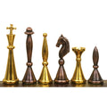 Complete lineup of modern luxury brass chess pieces showing the unique tall, slender silhouette.