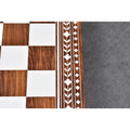 Macro shot of 45mm golden rosewood and white acrylic squares with ornate geometric floral borders.