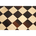 High-resolution detail of alternating rosewood and maple wood chess squares.