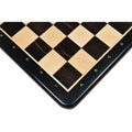 Corner of an ebony and maple chess board showing white algebraic number and letter notations.